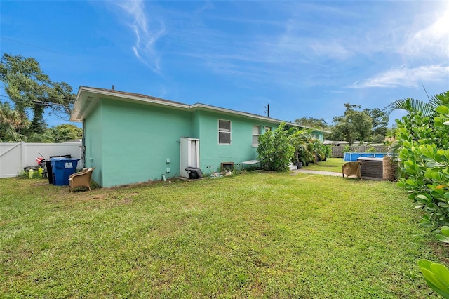 rear view of property with a yard