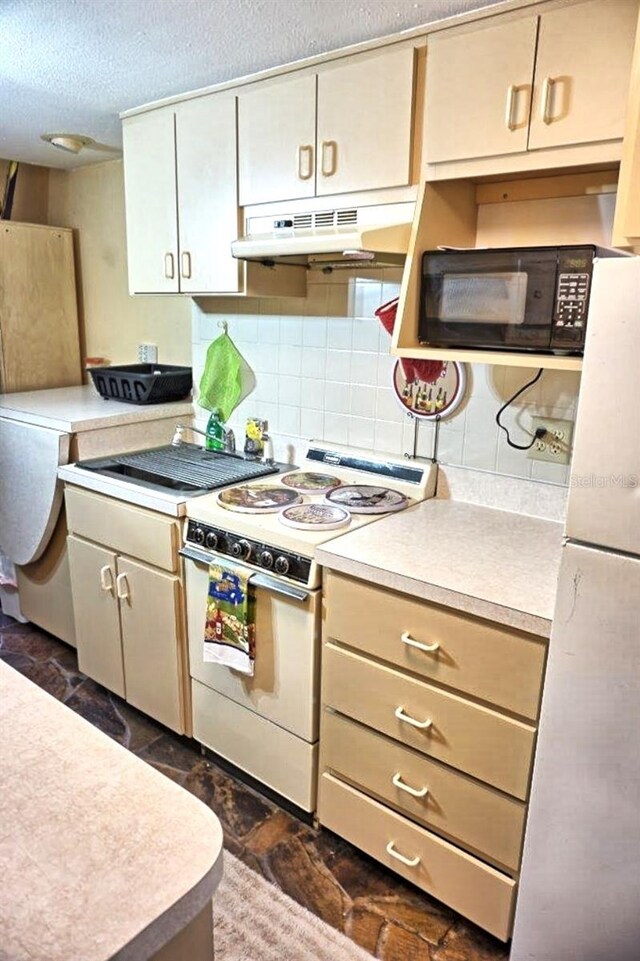 kitchen featuring white appliances, backsplash, and a textured ceiling