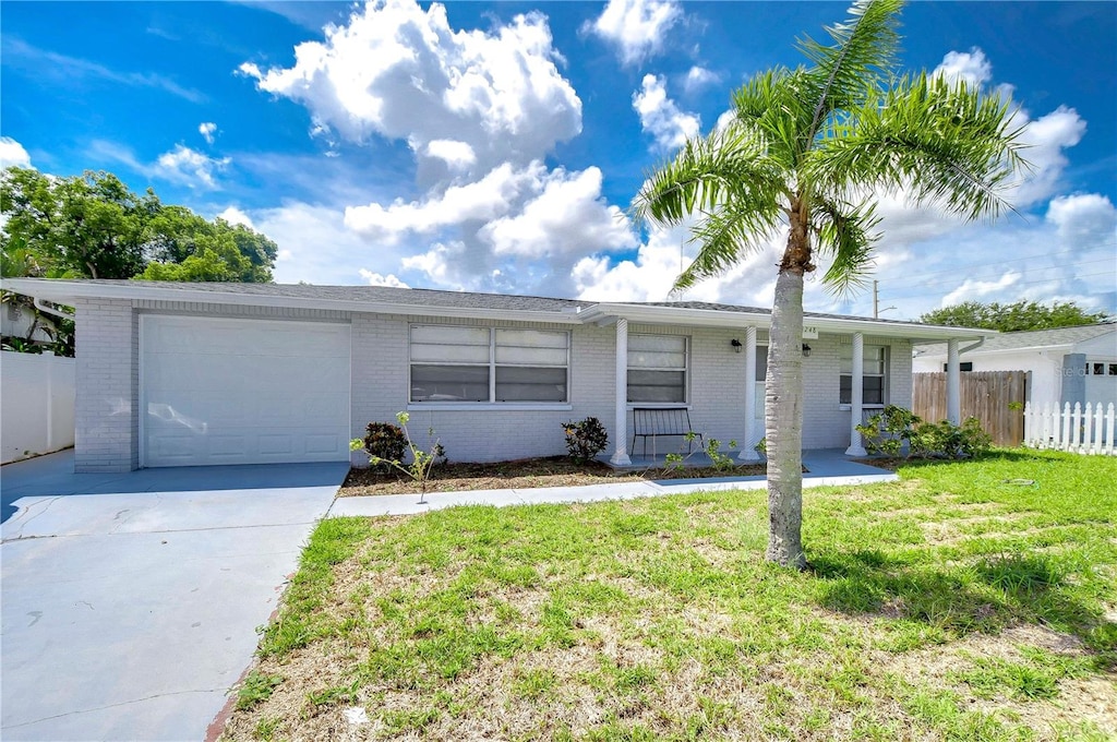 ranch-style home with a front yard and a garage