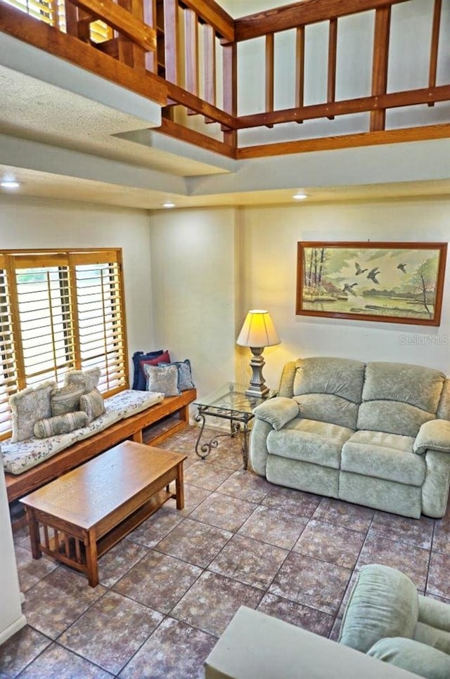 tiled living room with a towering ceiling