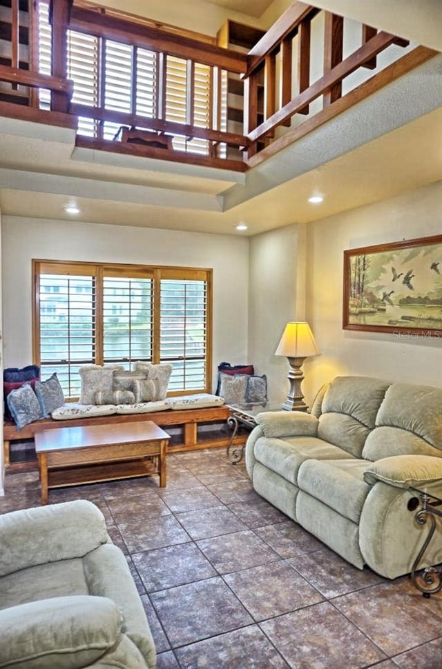 living room featuring a tray ceiling and a towering ceiling