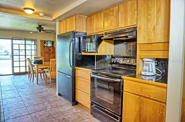 kitchen with dark tile patterned floors, black appliances, ceiling fan, tasteful backsplash, and a textured ceiling