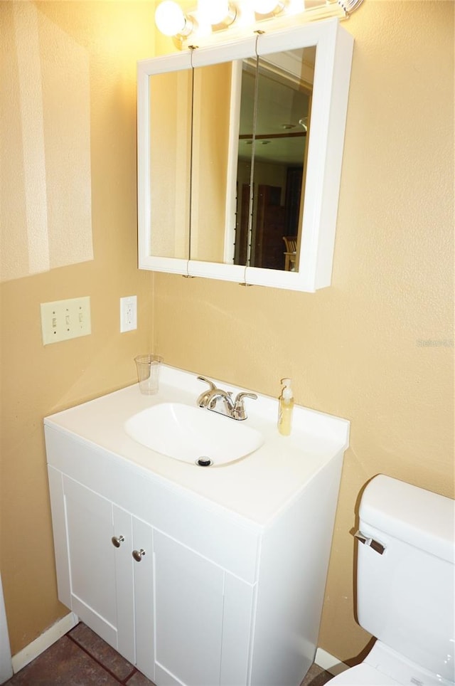 bathroom with toilet and vanity