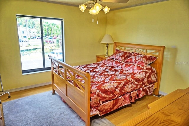 bedroom featuring ceiling fan and hardwood / wood-style floors