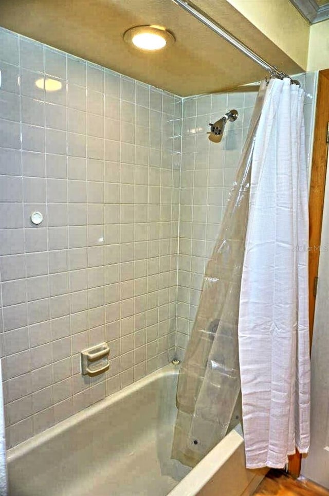 bathroom featuring shower / bathtub combination with curtain