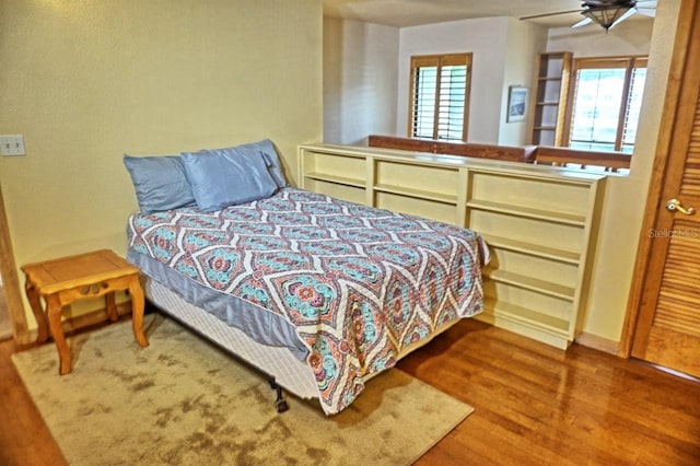 bedroom featuring wood-type flooring and ceiling fan