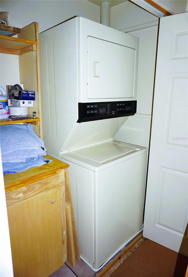 laundry room with stacked washer / drying machine