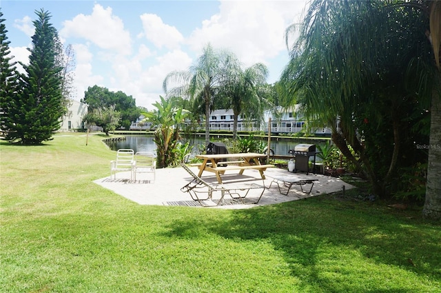 exterior space featuring a water view and a patio area