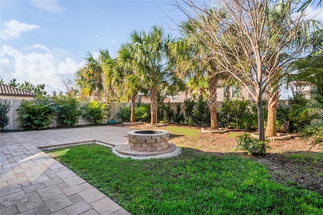 view of yard with a patio area, an outdoor fire pit, and a fenced backyard