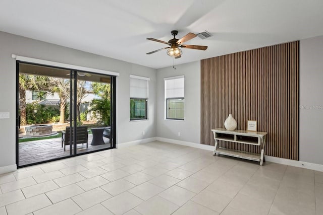 unfurnished room featuring ceiling fan and light tile patterned flooring