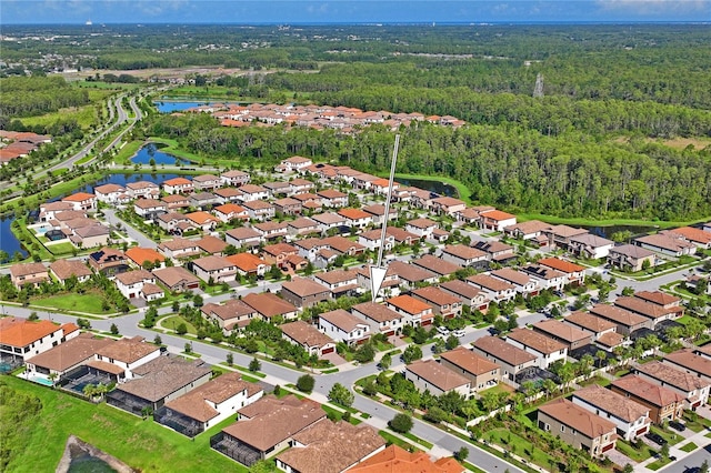 birds eye view of property with a view of trees, a water view, and a residential view