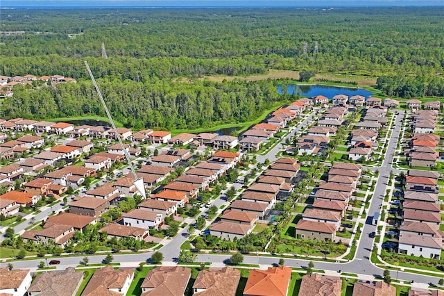 bird's eye view featuring a residential view, a forest view, and a water view