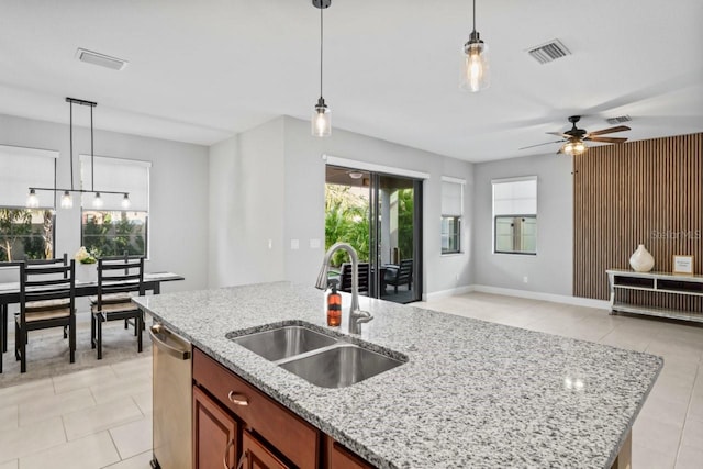 kitchen with visible vents, a sink, open floor plan, pendant lighting, and stainless steel dishwasher