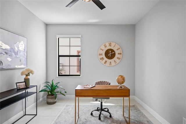 tiled office space featuring baseboards and a ceiling fan