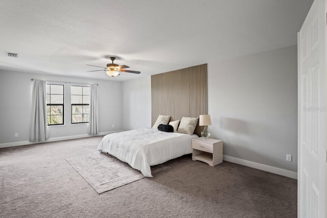 bedroom with visible vents, carpet floors, baseboards, and a ceiling fan