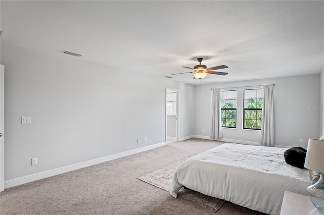 bedroom featuring visible vents, baseboards, carpet, and a ceiling fan