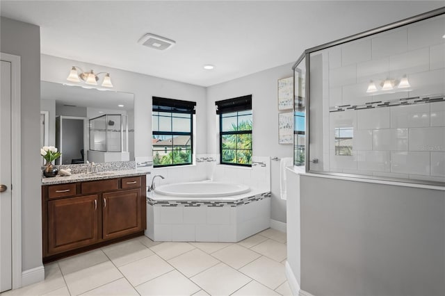 full bathroom with visible vents, a garden tub, a tile shower, tile patterned floors, and vanity