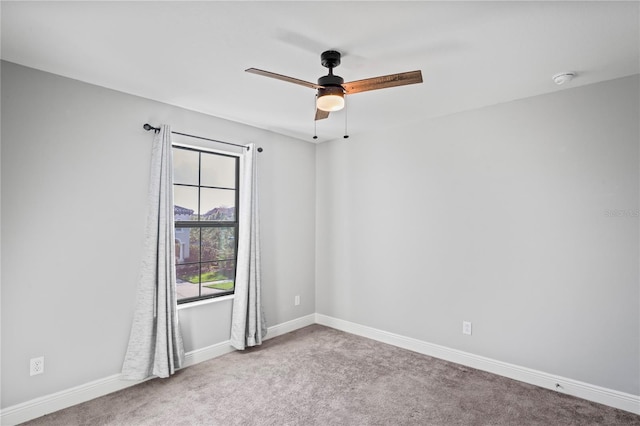 spare room with ceiling fan, baseboards, and carpet floors