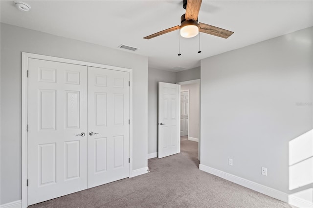 unfurnished bedroom with visible vents, baseboards, ceiling fan, carpet flooring, and a closet