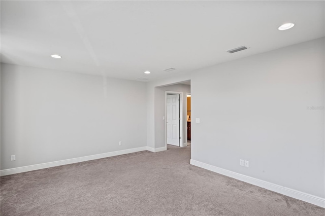 unfurnished room with recessed lighting, visible vents, carpet floors, and baseboards