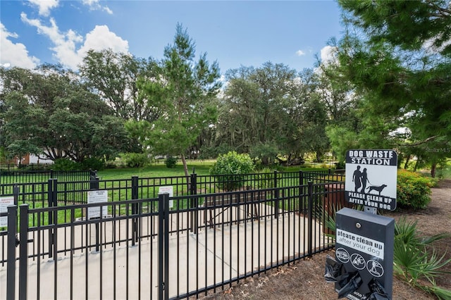 view of gate featuring a yard and fence