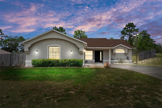 single story home with a yard