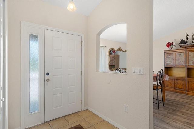 entrance foyer with light tile patterned floors and plenty of natural light