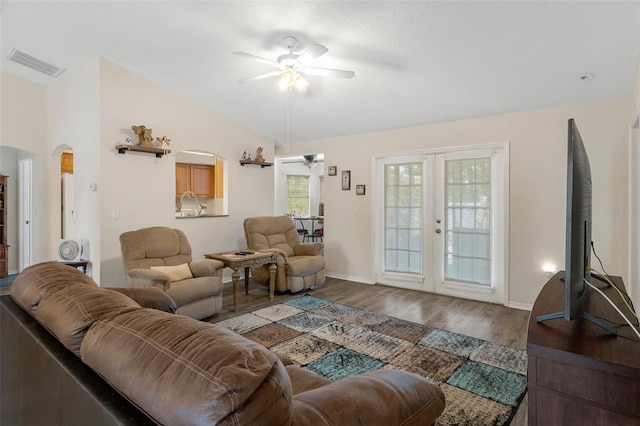 living room featuring ceiling fan, french doors, vaulted ceiling, and hardwood / wood-style flooring