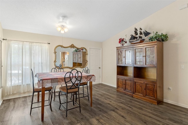 dining area with ceiling fan and dark hardwood / wood-style floors