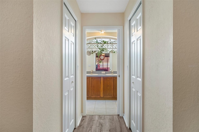 hall featuring sink and light hardwood / wood-style floors