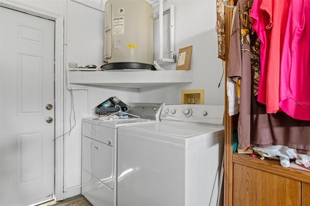 laundry room featuring water heater and washer and clothes dryer