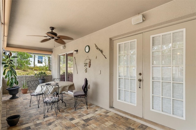 sunroom / solarium with ceiling fan and french doors