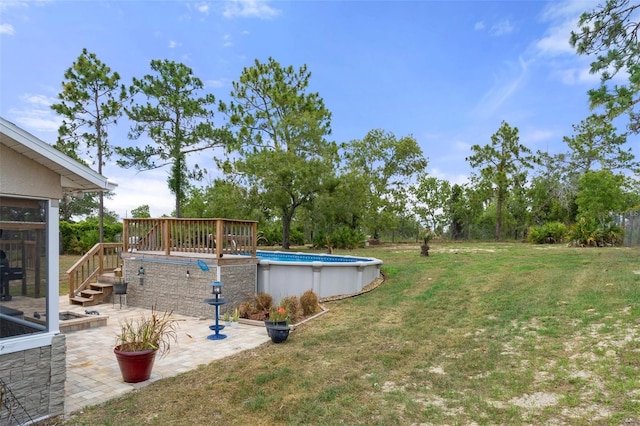 view of yard with a pool side deck and a patio area