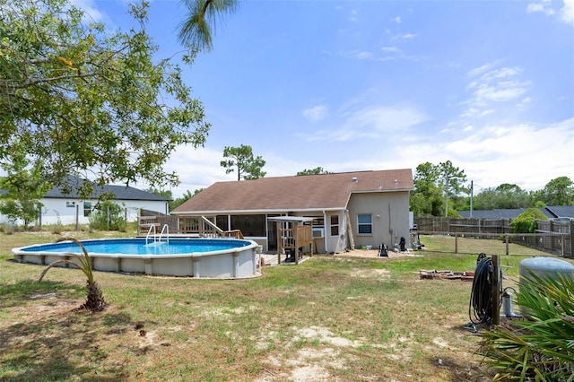 view of pool featuring a lawn