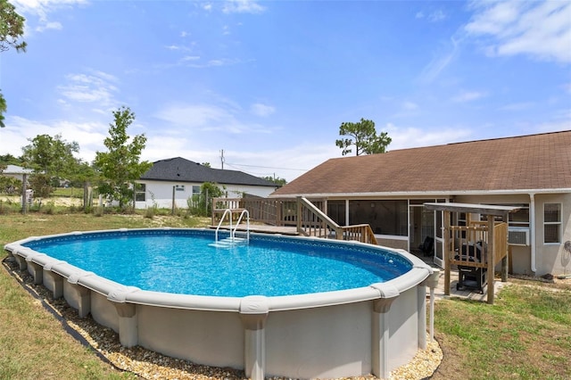 view of swimming pool with a sunroom