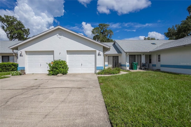 ranch-style house with a garage and a front lawn