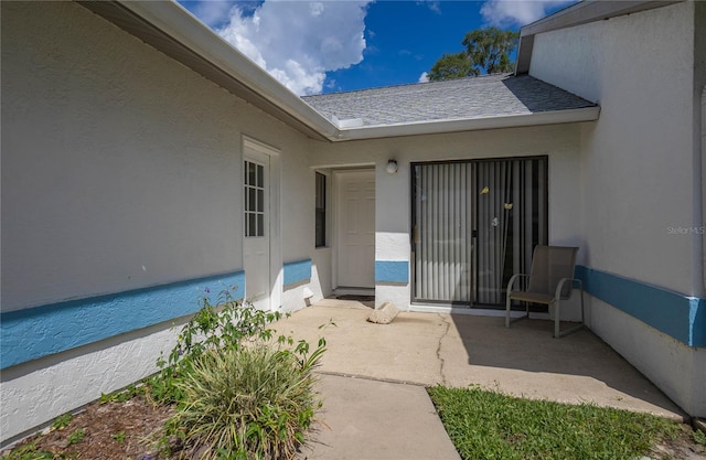 entrance to property featuring a patio area