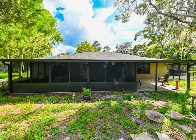 rear view of property with a patio and a sunroom