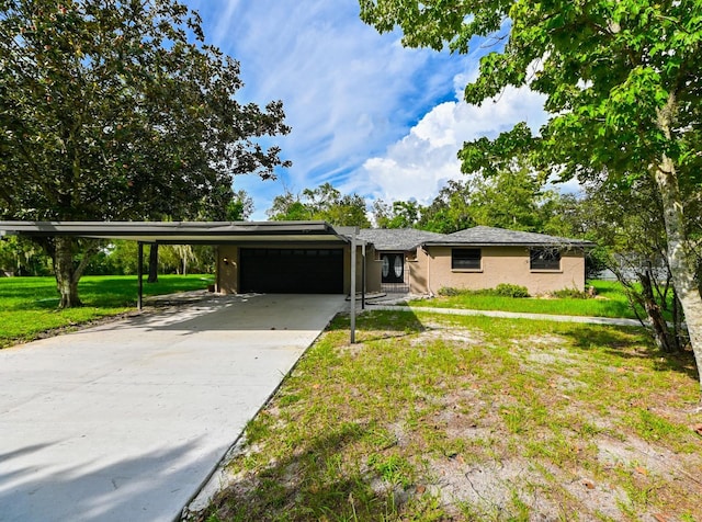 view of front of property featuring driveway, a front lawn, and an attached garage