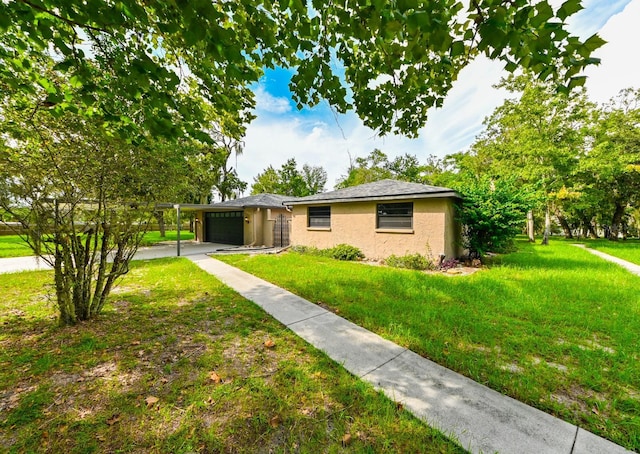 single story home with a front yard, an attached garage, driveway, and stucco siding