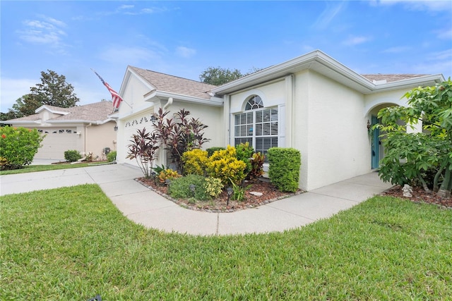 view of front of house with a front lawn and a garage