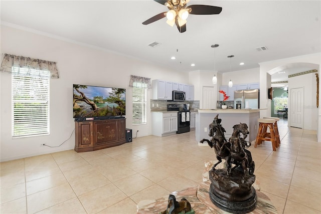 living room featuring ceiling fan, ornamental molding, and light tile patterned flooring