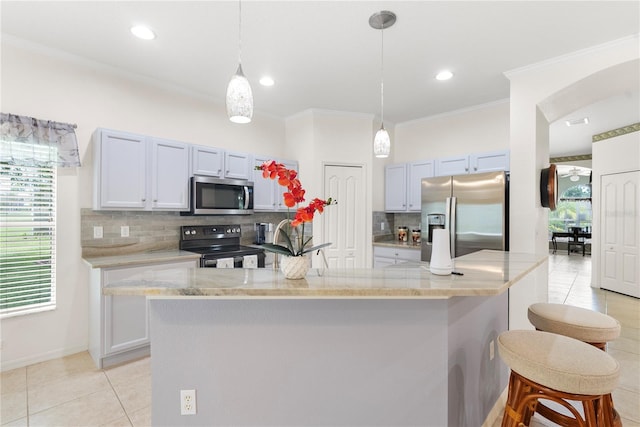 kitchen with decorative light fixtures, appliances with stainless steel finishes, decorative backsplash, and ornamental molding