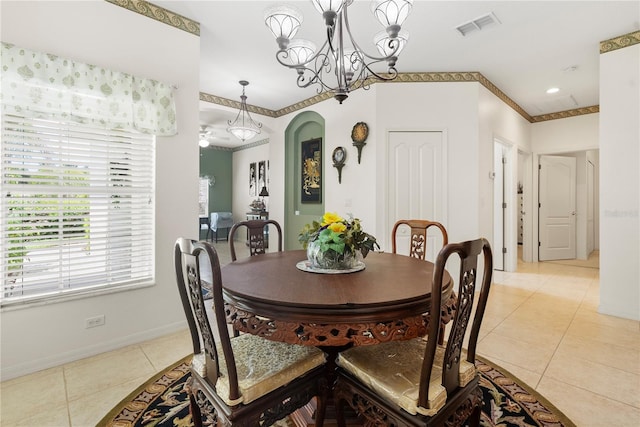 dining area featuring ornamental molding, a chandelier, and light tile patterned flooring