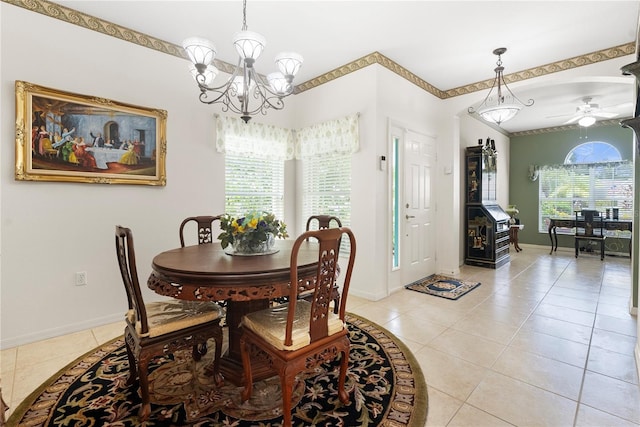 tiled dining area with ceiling fan with notable chandelier