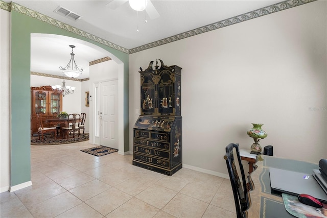 tiled office space with ceiling fan with notable chandelier