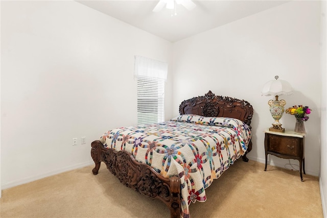 bedroom with ceiling fan and light carpet