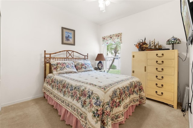 bedroom with ceiling fan and light colored carpet