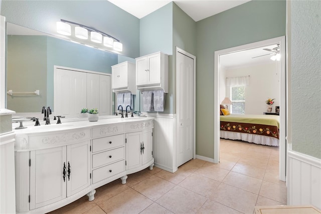 bathroom with tile patterned flooring, ceiling fan, and vanity