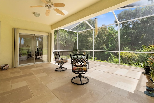 unfurnished sunroom featuring plenty of natural light and ceiling fan